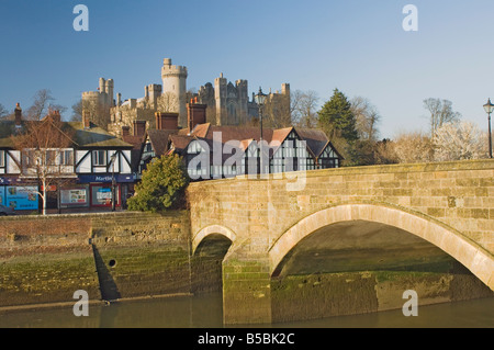 Arundel Castle from across tidal inlet with town bridge with half timbered town houses, Arundel, West Sussex, England, Europe Stock Photo