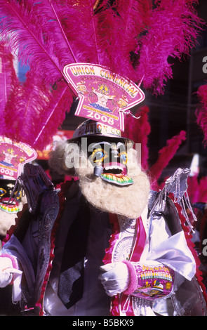 Portrait of a rey moreno morenada dancer wearing a mask and pink feather headdress, Gran Poder festival, La Paz, Bolivia Stock Photo