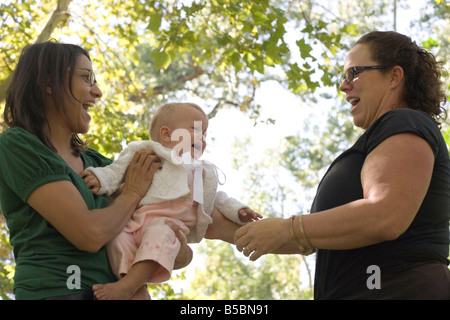 baby girl crying in fear when stranger attempts to hold her, outdoors, southwestern united states Stock Photo