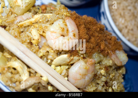 Thai fried rice shrimp chicken pork in curry spicy sauce with minced pork on top at chinese restaurant Stock Photo