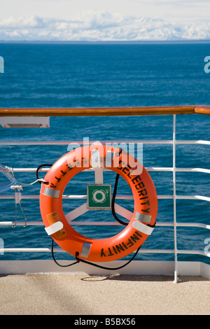 Life saver ring mounted on railing of Celebrity Cruise Lines Infinity ship sailing the Inside Passage in Alaska Stock Photo