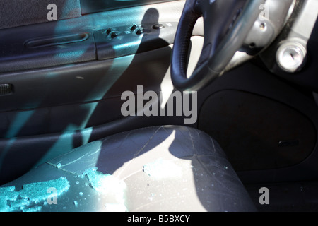 The broken window of a car after a break in Stock Photo