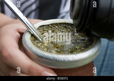 A young girl in Argentina prepares and drinks mate in the trendy neighbourhood of Recoleta, Buenos Aires, Argentina Stock Photo
