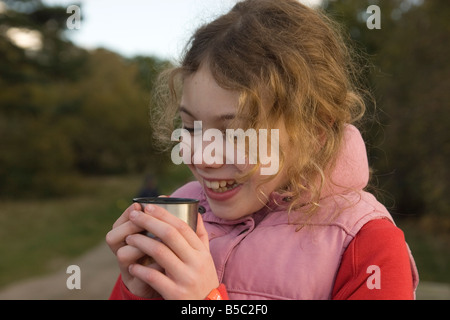 girl drinking hot chocolate outdoors Stock Photo