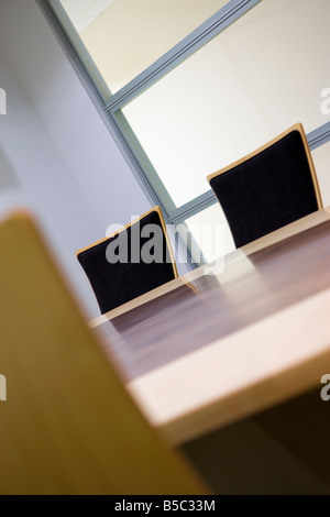 THREE CHAIRS IN AN EMPTY BOARDROOM Stock Photo