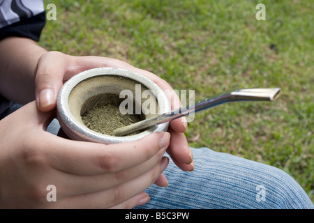 A young girl in Argentina prepares and drinks mate in the trendy neighbourhood of Recoleta in Buenos Aires Stock Photo
