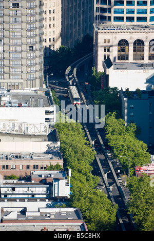Seattle Center Monorail cuts through the Downtown District of Seattle Washington, USA Stock Photo