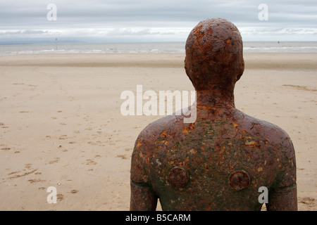 [Antony Gormley] sculpture, head and shoulders of metal statue from behind, Crosby Beach, Sefton Coast, Merseyside, England, UK Stock Photo