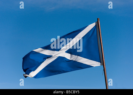 Scots flag Saltire St Andrews cross blue sky flying - direction left image may be flipped to suit layout Stock Photo