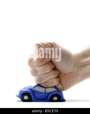 A MODEL CAR HIT AND SQUASHED BY A MANS FIST. Stock Photo