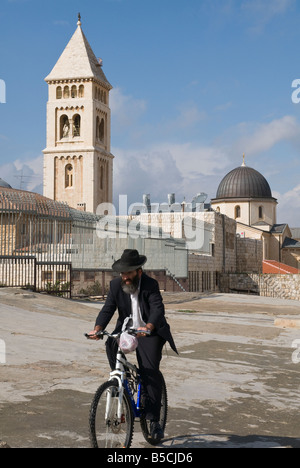 Israel Jerusalem Old City orthodox jew riding a bicycle with redeemer church in bkgd Stock Photo
