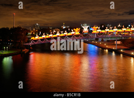 Toronto Skyline wind turbine and bridge at Ontario Place with Chinese Lanterns reflected in Lake Ontario at night Stock Photo