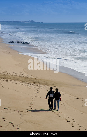 Middle Aged Couple Walking on a Beach Stock Photo