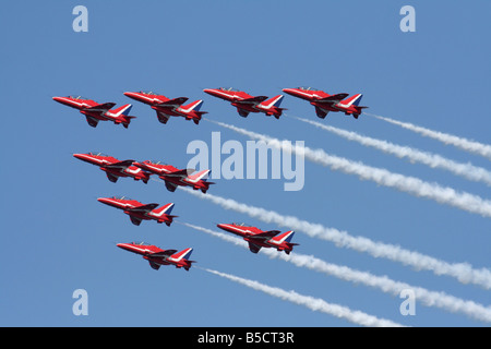 The Royal Air Force Red Arrows aerobatic team flying in formation and generating smoke trails Stock Photo