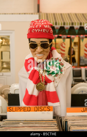 Elvis Presley figure dressed in welsh national memorabilia on 'Slipped Discs' record stall in Carmarthen indoor market, Wales UK Stock Photo