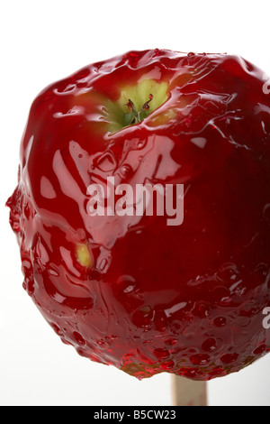 candy apple covered in dripping red candy traditionally eaten in ireland at Halloween Stock Photo