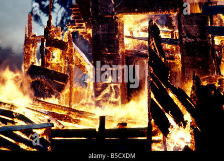 Inferno, flames consuming wood structure home. Stock Photo