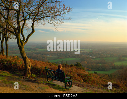 Person looking across the Weald with a view to the South Downs from the Greensand Ridge, Pitch Hill, Ewhurst, Surrey, England Stock Photo