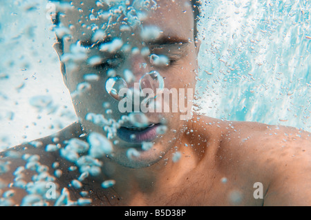 Man holding breath underwater Stock Photo