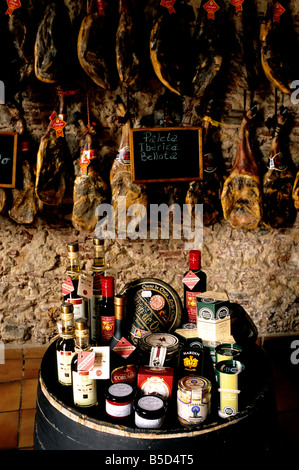 Gourmet produce displayed inside a delicatessen in Ayamonte, Spain. Foodstuffs for sale include jamón (ham) ibérico de bellota Stock Photo