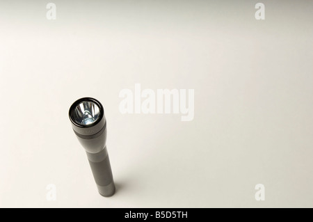 Flashlight torch with an aluminum body and LED electronic construction on a white background. Stock Photo