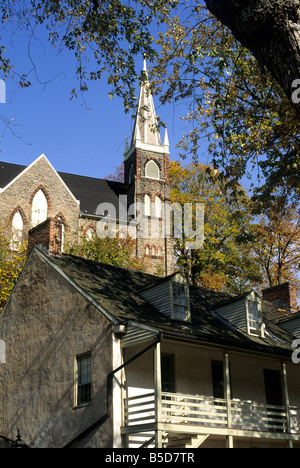 Old Town Church looms above restored 19th century buildings that line Shenandoah St in Harpers Ferry National Historic Park, WV Stock Photo
