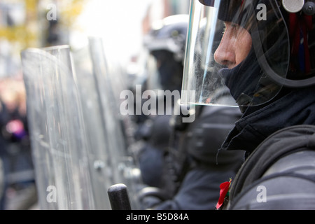 close up of line of PSNI Police Service of Northern Ireland riot officers form a protective barrier with riot shields during dis Stock Photo