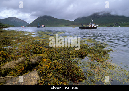 Fishing boats on Loch Slapin, Red Hills including Beinn na Cro, Beinn Dearg Mhor, Isle of Skye, Inner Hebrides, Scotland Stock Photo