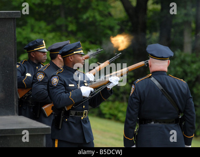 A police honor guard fires a 21 gun salute for a Police officer killed in the line of duty in New Haven Connecticut USA Stock Photo