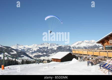 Parapente with skiers in blue sunny sky near chalet. St Gervais Haute Savoie France. Horizontal.  50427 Montblanc-Ski2005 Stock Photo