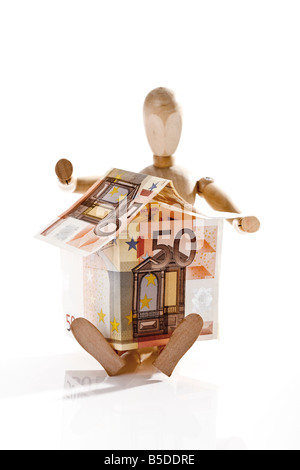 Manikin holding House made from Euro notes Stock Photo