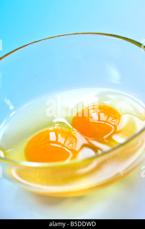 Raw eggs in a glass bowl close up Stock Photo