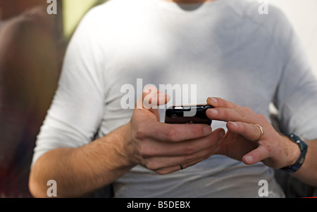 Man hand holding an iPhone Stock Photo