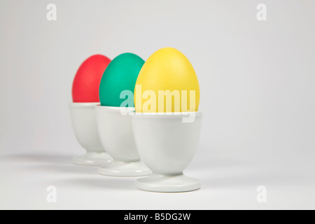 Colored Easter eggs in egg cups Stock Photo