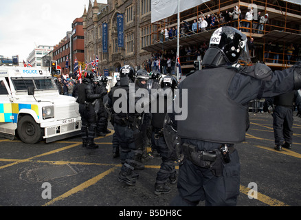 line of PSNI Police Service of Northern Ireland riot squad control officers form defensive line during loyalist protest belfast Stock Photo