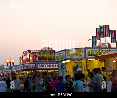 People at concession stands in the midway of a county fair Stock Photo