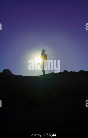 Silhouette Of Hiker Mountain Climber With Bright Sun At Summit Of Camelback Mountain, Phoenix, Arizona, USA Stock Photo
