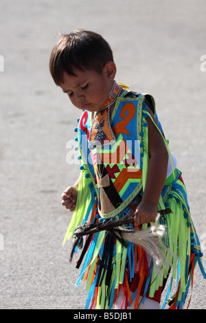 A young Native American Indian boy dancing in a fancy outfit at a Pow Wow at the Milwaukee Lakefront Indian Summer Festival WI Stock Photo