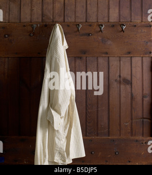 Work Shirt Hanging On Hook Weathered Wood Wall Stock Photo