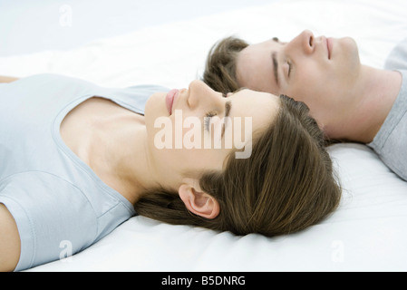 Couple sleeping, heads side by side Stock Photo