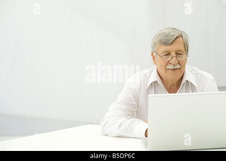 Senior man using laptop computer Stock Photo
