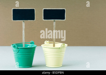 Two dessert buckets with decorative signs, side by side Stock Photo