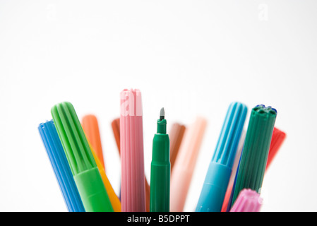 Tops of multicolored felt tip pens, one missing its cap, close-up Stock Photo