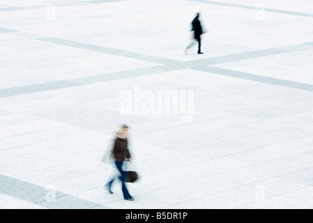 Pedestrians crossing public square Stock Photo