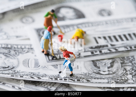 Miniature cleaning ladies washing play money Stock Photo