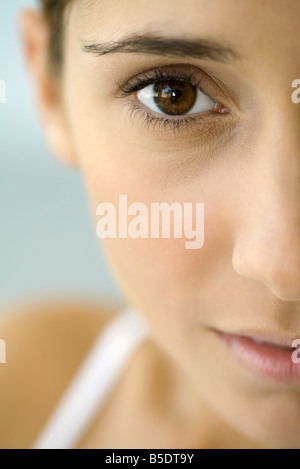 Woman looking at camera, extreme close-up, cropped Stock Photo