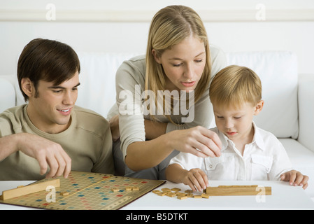 Family playing board game together Stock Photo