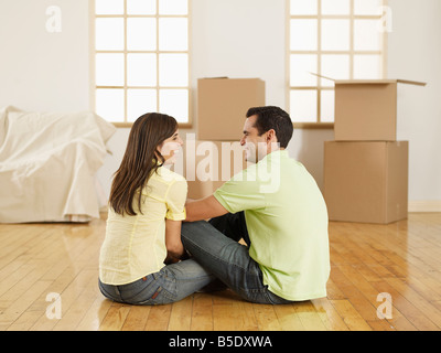 Couple Talking near Cardboard Boxes Stock Photo