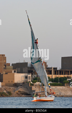 Lowering the Sail on a Felucca Sailboat on the Nile River in Luxor Egypt Stock Photo