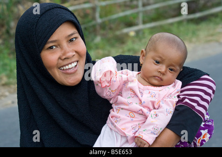 Young Indonesian Mother and Baby in Senggigi on Lombok Island in Indonesia Stock Photo